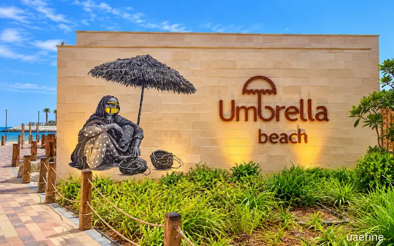 Umbrella Beach entrance wall with mural and landscaped greenery