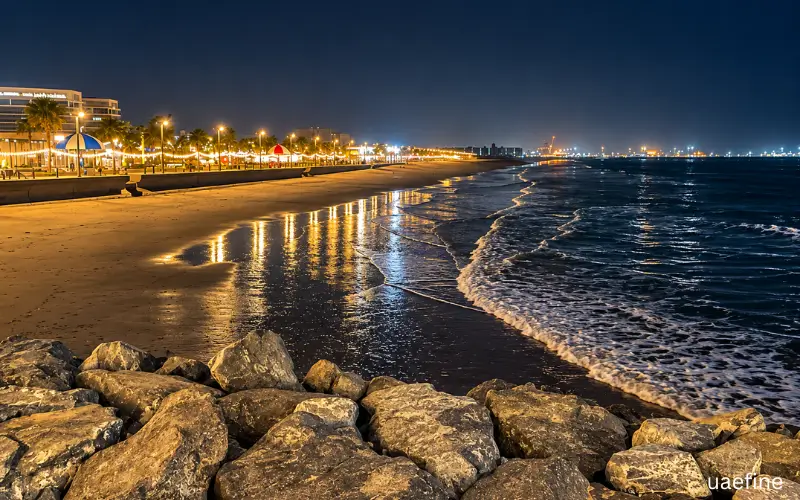 1. Nighttime beach with illuminated promenade, wet sand reflections and ocean waves.